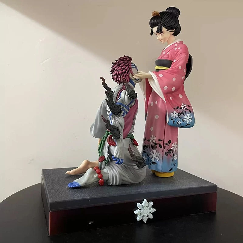 Two figurines in traditional attire on a black base with a plain background Demon Slayer: Kimetsu no Yaiba Akaza (Hakuji) & Koyuki Authentic 10.43-Inch PVC Diorama Statue Figure – The Past Memories Edition