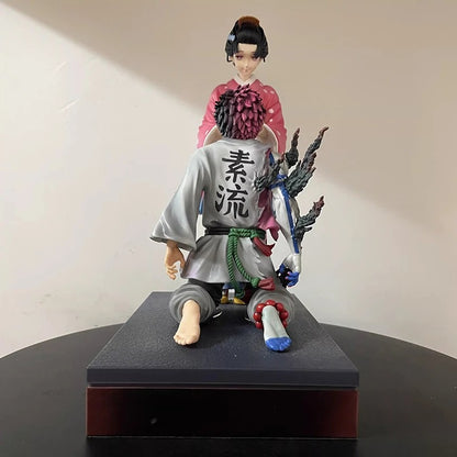 Figurine of a character in traditional attire with a weapon on a black base against a beige background Demon Slayer: Kimetsu no Yaiba Akaza (Hakuji) & Koyuki Authentic 10.43-Inch PVC Diorama Statue Figure – The Past Memories Edition