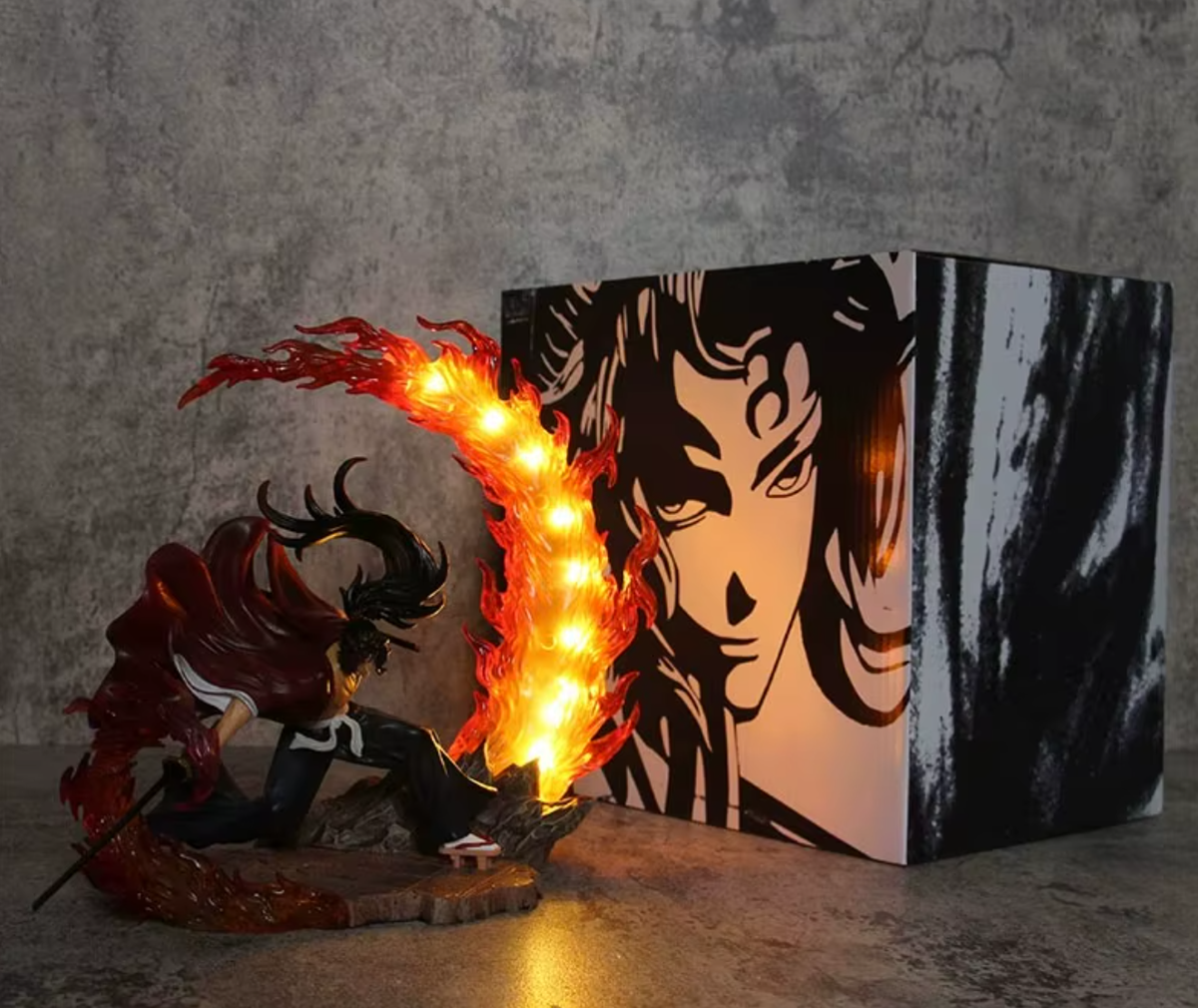 Anime character figurine with glowing light effects next to a stylized illustration on a concrete surface. Demon Slayer: Kimetsu no Yaiba Legendary Twin Bloodlines Premium PVC Combat Statue – Yoriichi Tsugikuni / Kokushibo Upper Moon One box