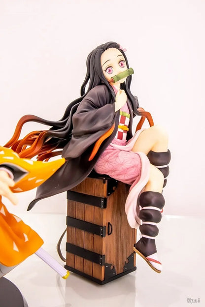 Anime character figurine with long hair and a green object in her mouth, sitting on a wooden box. Demon Slayer: Kimetsu no Yaiba Nezuko Kamado Authentic 15cm Sitting PVC Figure – Box Perch Display Edition
