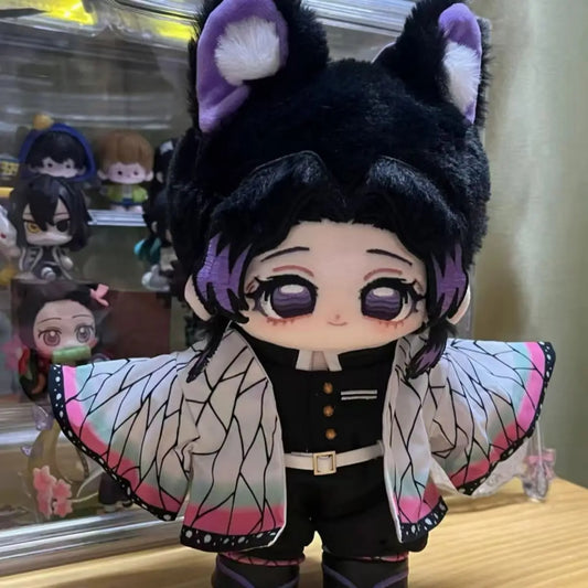 Plush toy of a character with black hair, purple eyes, and butterfly wings in front of a display case. Demon Slayer: Kimetsu no Yaiba Shinobu Kocho Premium 20cm Super Soft Plushie Doll – Fluffy Purple-Eared Animal Hood Edition