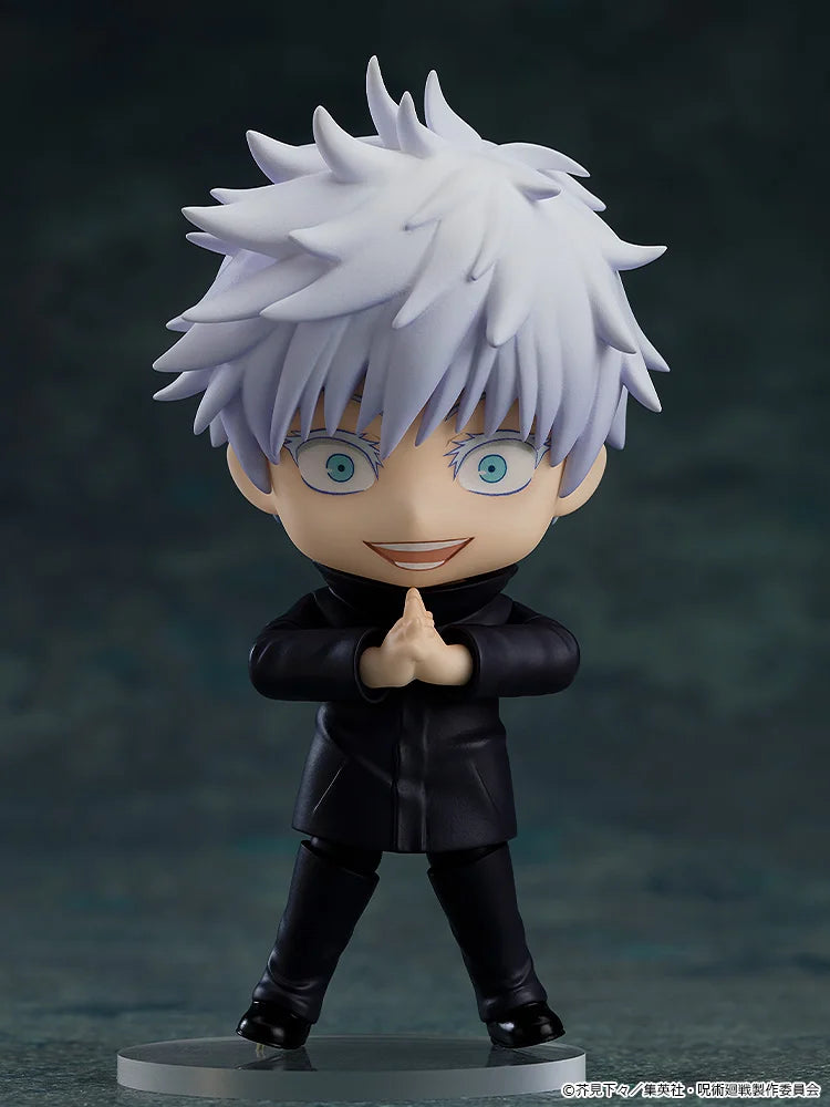 Figurine of a character with spiky white hair and blue eyes, wearing a black outfit on a dark background. Jujutsu Kaisen Nendoroid No. 1528 Satoru Gojo Authentic 10cm Chibi Action Figure – Modern World's Strongest Sorcerer Edition pose