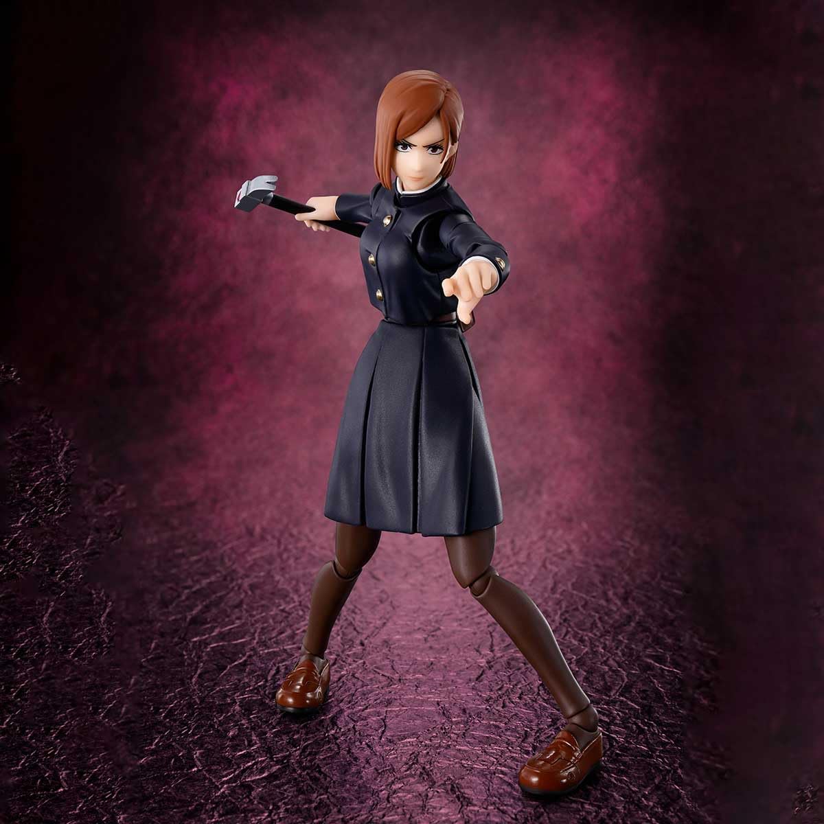 Action figure in a dark outfit with a weapon on a textured purple background Jujutsu Kaisen S.H.Figuarts Nobara Kugisaki Authentic 13.5cm Articulated Action Figure – Straw Doll Technique Edition
