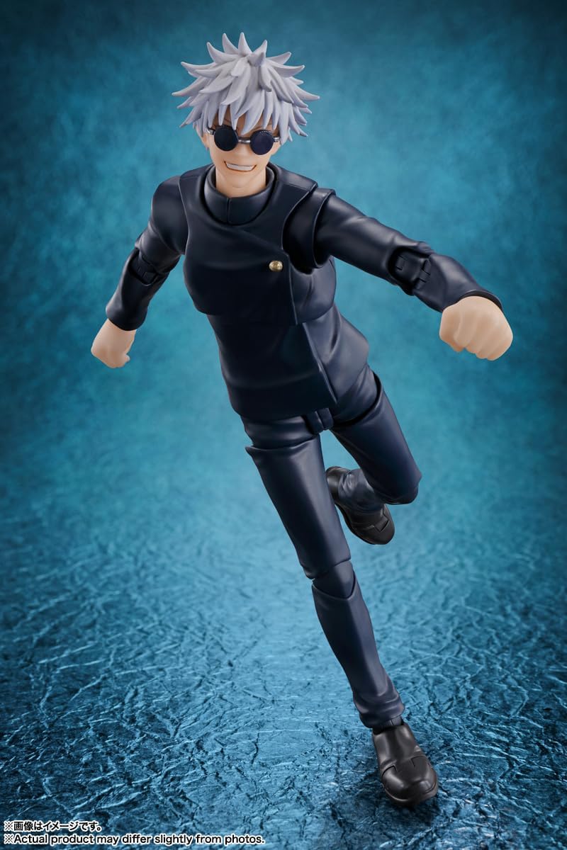 Action figure of a character in black outfit with sunglasses on a blue textured background Jujutsu Kaisen S.H.Figuarts Satoru Gojo Authentic 16cm Articulated Action Figure – Tokyo Jujutsu High School Edition