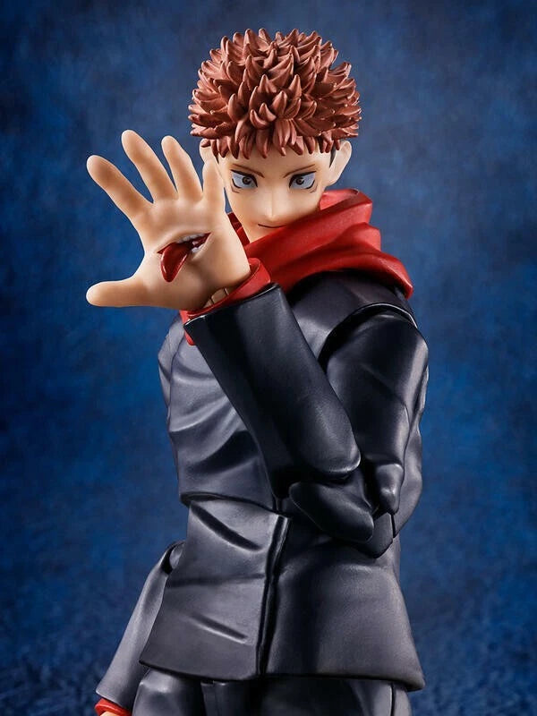 Figurine of a character with spiky hair and red scarf against a blue background Jujutsu Kaisen S.H.Figuarts Yuji Itadori Authentic 15cm Articulated Action Figure – Original Standard First Edition hand