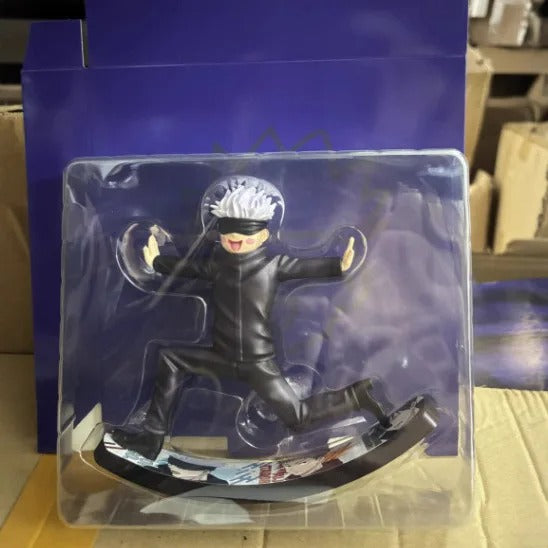 Action figure in packaging with a blue background Jujutsu Kaisen Satoru Gojo Authentic 6.6-Inch Playful Swing PVC Figure – Kinetic Rocking Base & Joyful Blindfold Edition box