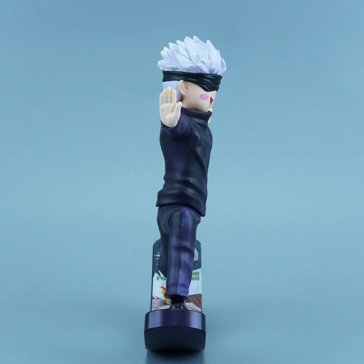 Action figure of a character with white hair and black clothing on a blue background Jujutsu Kaisen Satoru Gojo Authentic 6.6-Inch Playful Swing PVC Figure – Kinetic Rocking Base & Joyful Blindfold Edition side 1