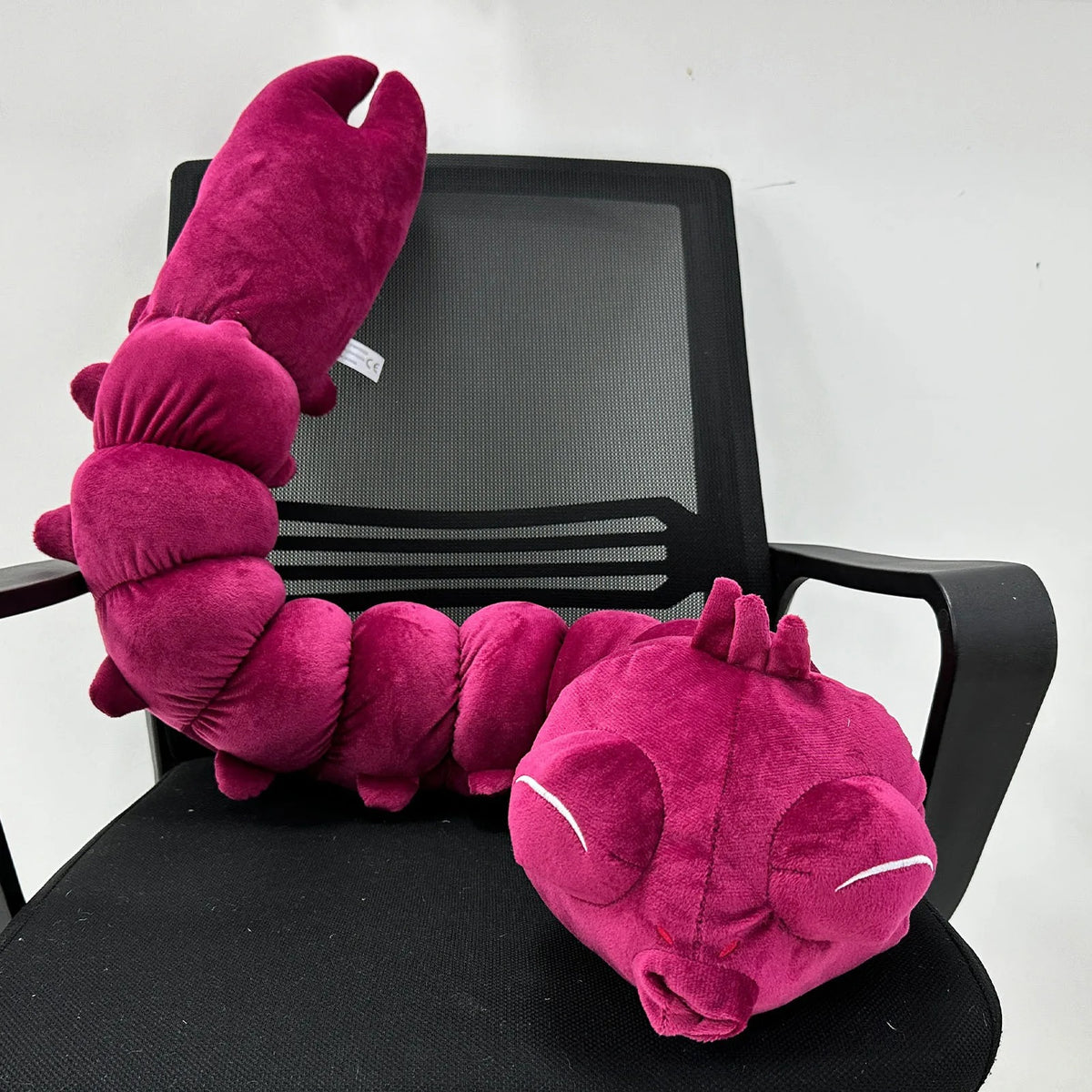 Pink plush toy shaped like a lobster on a black office chair. Jujutsu Kaisen Toji Fushiguro Inventory Cursed Spirit Authentic Huggable Plush Doll – "Ugly Treasure" Special Grade Cosplay Companion & Room Decor Plush