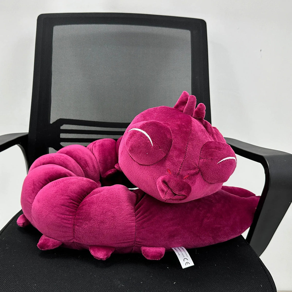 Pink dragon-shaped pillow on a black office chair with a white background Jujutsu Kaisen Toji Fushiguro Inventory Cursed Spirit Authentic Huggable Plush Doll – "Ugly Treasure" Special Grade Cosplay Companion & Room Decor Plush