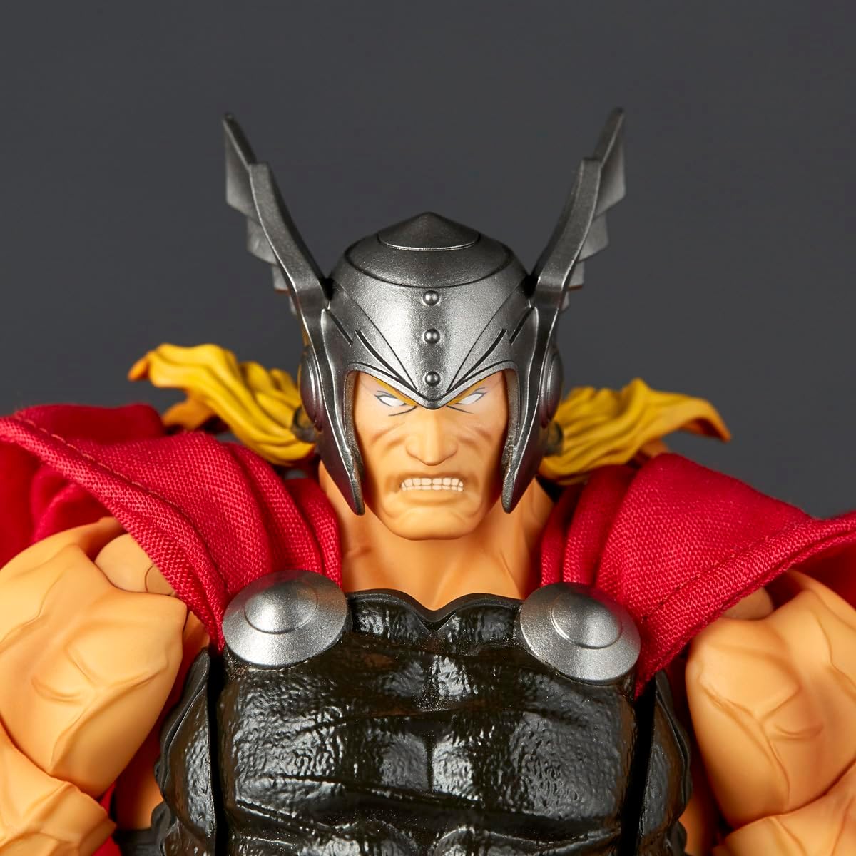 Thor's Hammer action figure close-up showing the detailed sculpted face, black winged helmet, red cape, and textured armor against a dark gray background. Marvel Amazing Yamaguchi Revoltech NR018 Thor Authentic Action Figure
