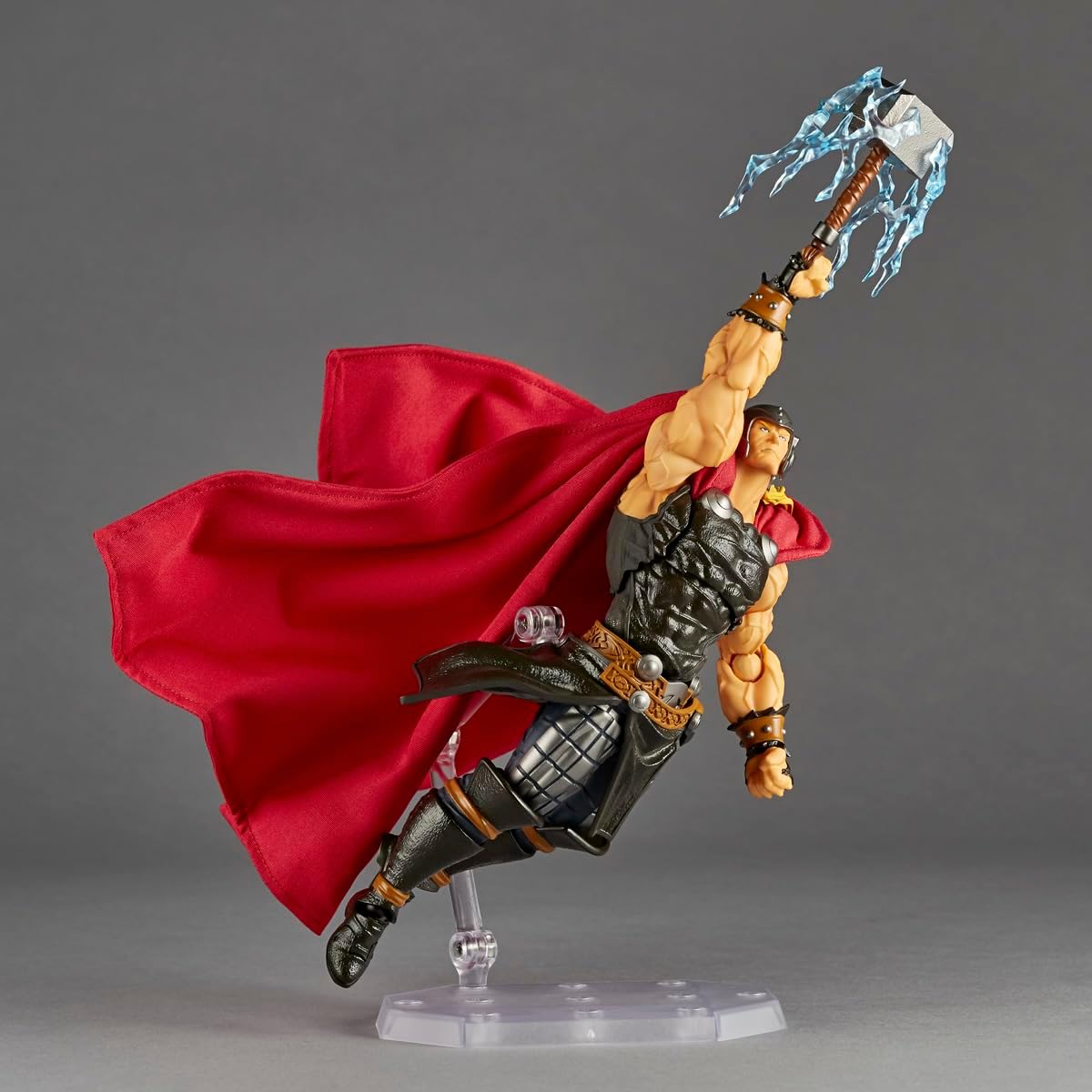 Thor action figure posed mid-leap with a flowing red cape and holding Mjolnir, displayed on a clear stand against a gray studio background. Marvel Amazing Yamaguchi Revoltech NR018 Thor Authentic Action Figure