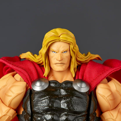 Close-up of a Thor action figure showing the face, blonde hair, red cape, and black armor against a dark gray background. Marvel Amazing Yamaguchi Revoltech NR018 Thor Authentic Action Figure