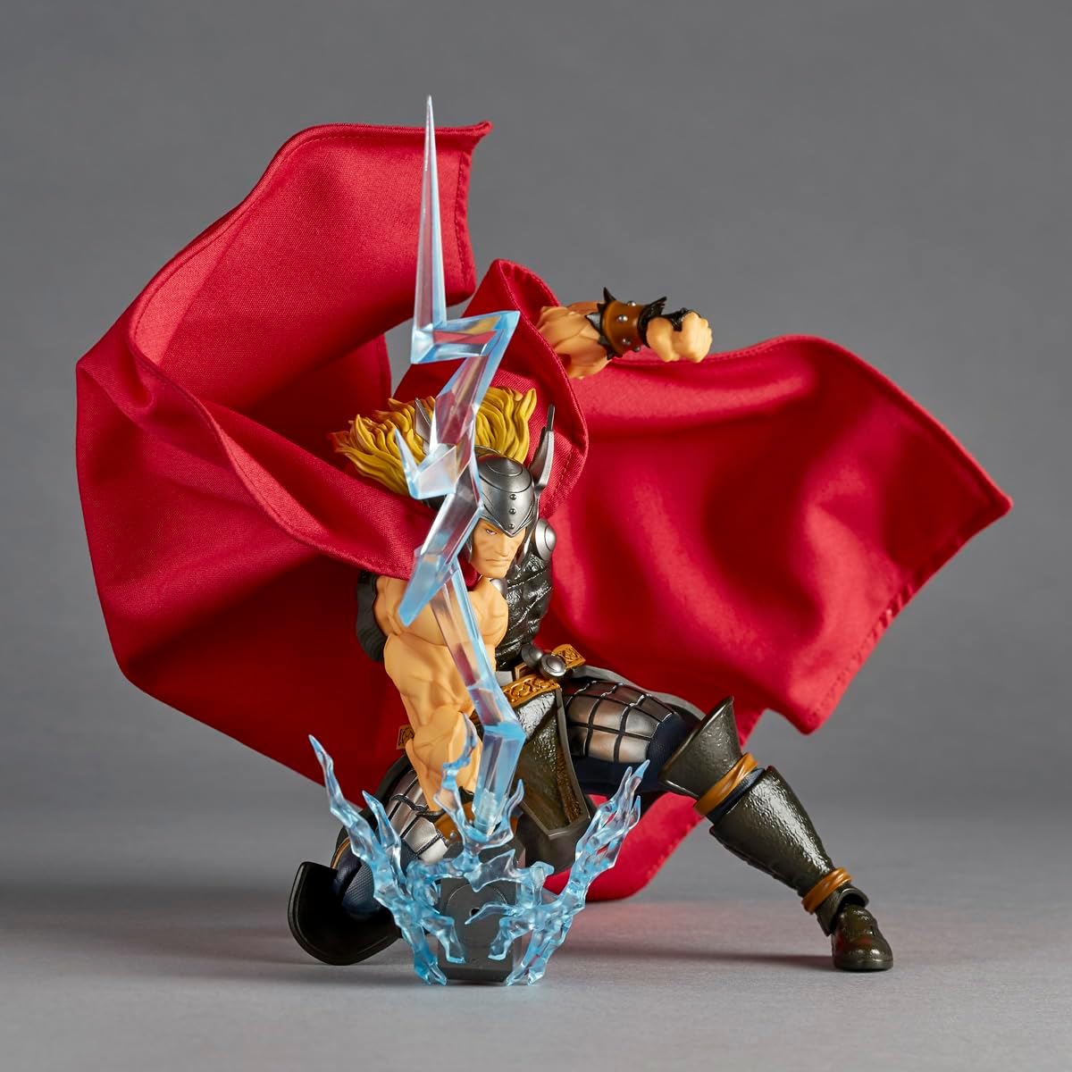 Thor action figure posed with a large red cape, holding a blue lightning bolt accessory, on a gray studio background. Marvel Amazing Yamaguchi Revoltech NR018 Thor Authentic Action Figure