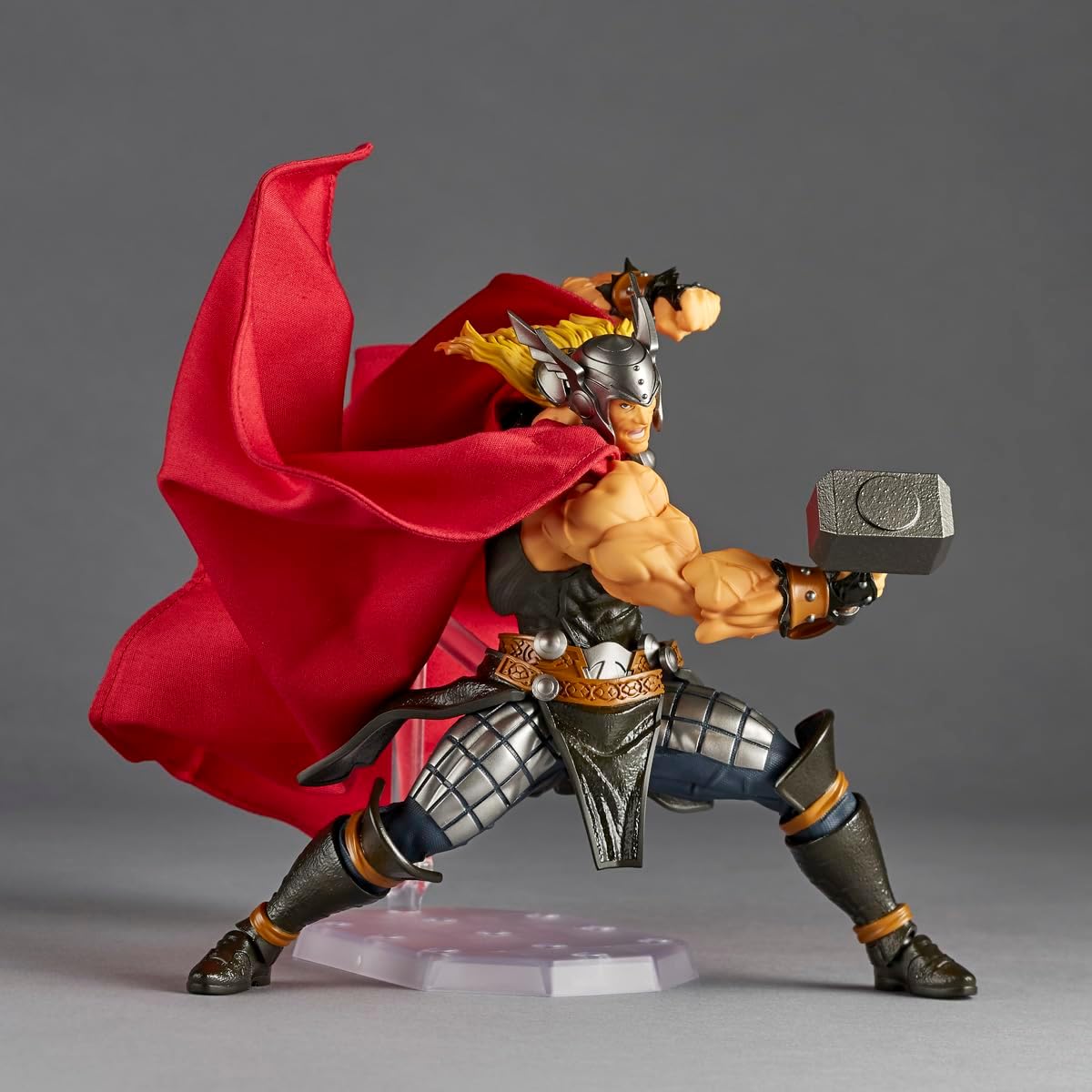 Thor action figure posed in a dynamic battle stance with Mjolnir, featuring a flowing red cape, silver helmet, and detailed muscular anatomy on a gray studio background. Marvel Amazing Yamaguchi Revoltech NR018 Thor Authentic Action Figure