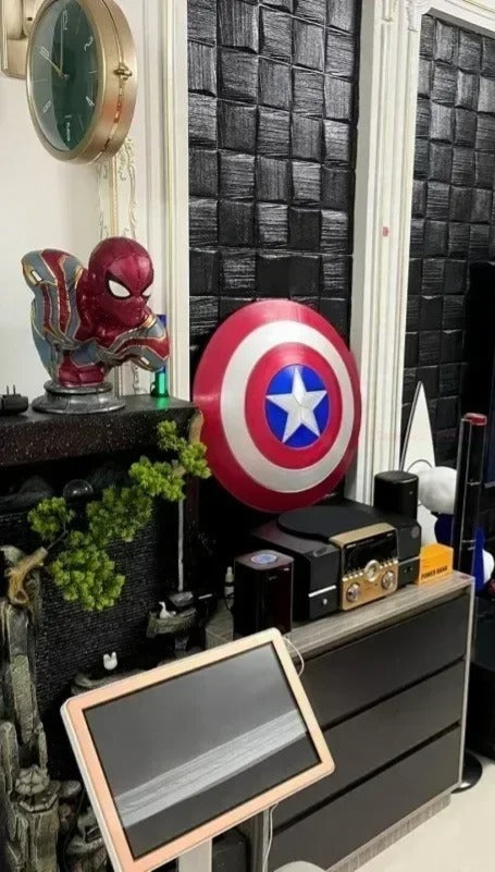 Room interior with superhero-themed decor, including a Captain America shield and Spider-Man figure. Marvel Captain America 47.5cm Full Metal Prop Replica Shield