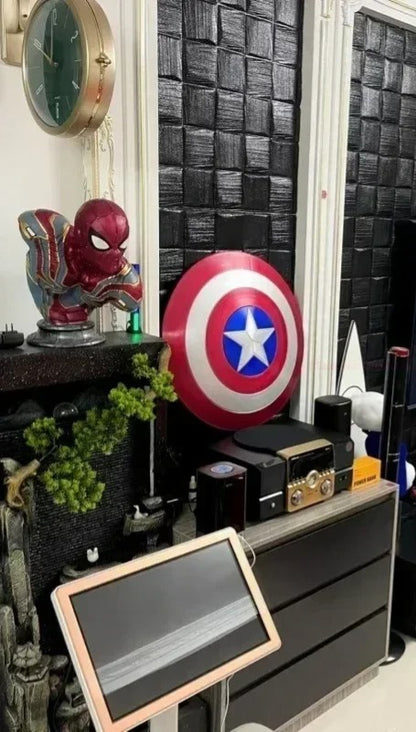Room interior with superhero-themed decor, including a Captain America shield and Spider-Man figure. Marvel Captain America 47.5cm Full Metal Prop Replica Shield