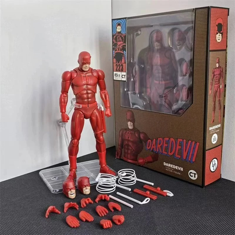 Red superhero action figure with accessories and packaging on a gray surface. Marvel Comics Daredevil (Classic Comic Version No. 223) 1/12 Scale Premium Action Figure by CT Toys