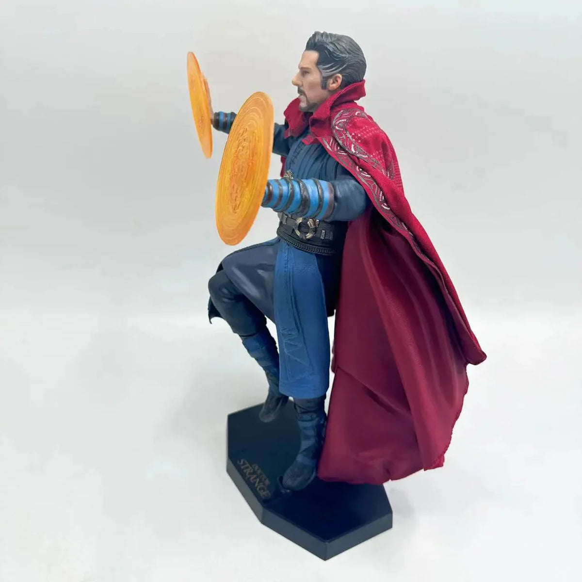 Superhero figurine with red cape and blue outfit holding orange discs on a white background Marvel Doctor Strange (Sorcerer Supreme Edition) 28cm Premium Figure by Crazy Toys