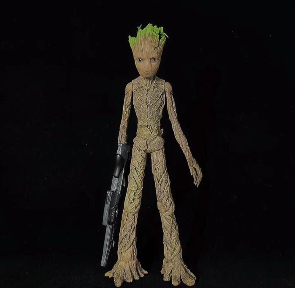 Action figure of a character with green hair and a weapon on a black background Marvel Guardians of the Galaxy Groot 1/6 Scale Premium Figure by Empire Toys