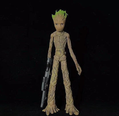 Action figure of a character with green hair and a weapon on a black background Marvel Guardians of the Galaxy Groot 1/6 Scale Premium Figure by Empire Toys