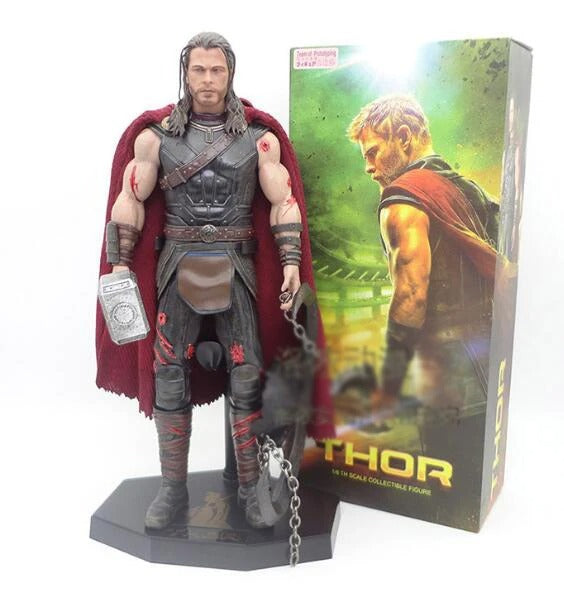 Thor action figure with red cape and hammer next to its packaging Marvel Thor: Ragnarok (Surtur's Skull Edition) 1/6 Scale Premium Figure by Crazy Toys