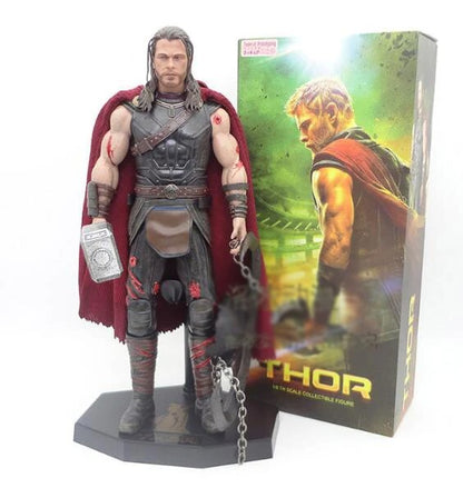 Thor action figure with red cape and hammer next to its packaging Marvel Thor: Ragnarok (Surtur's Skull Edition) 1/6 Scale Premium Figure by Crazy Toys