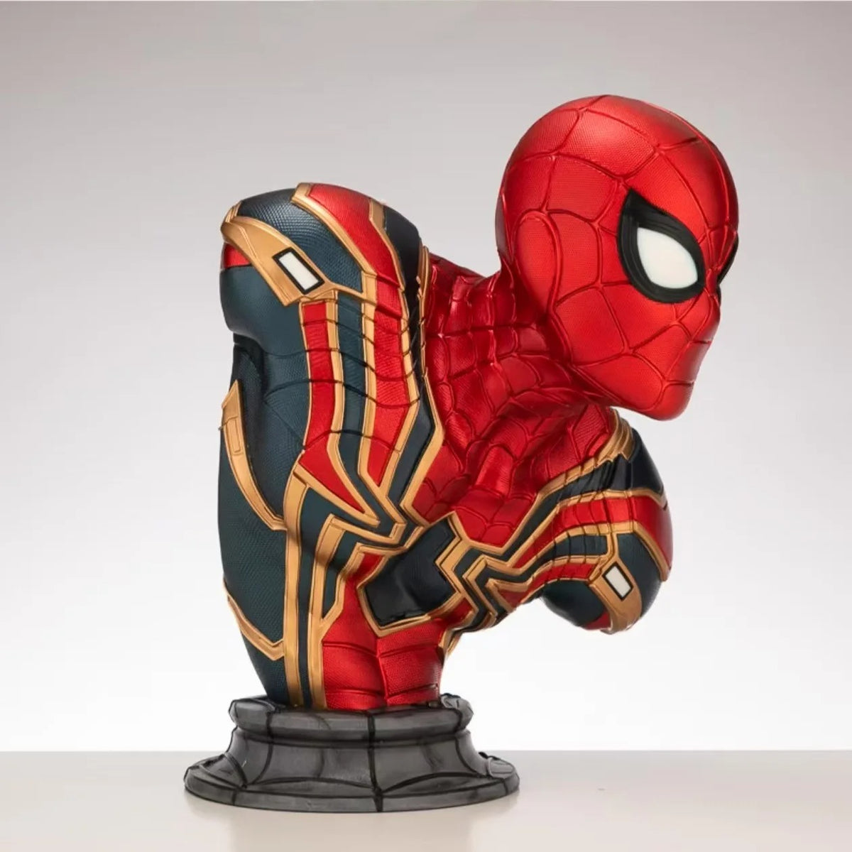 Spider-Man figurine with red, blue, and gold suit on a white background Marvel Universe Spider-Man 1:1 Life-Size Premium Portrait Bust