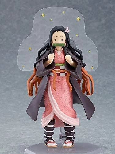 Action figure of a character from an anime or manga with long black and orange hair, wearing a pink outfit and gray cloak. Max Factory figma Demon Slayer: Kimetsu no Yaiba: Nezuko Kamado Authentic Premium Action Figure – Deluxe DX Edition