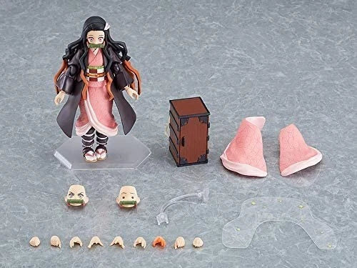 Action figure with accessories on a gray surface Max Factory figma Demon Slayer: Kimetsu no Yaiba: Nezuko Kamado Authentic Premium Action Figure – Deluxe DX Edition