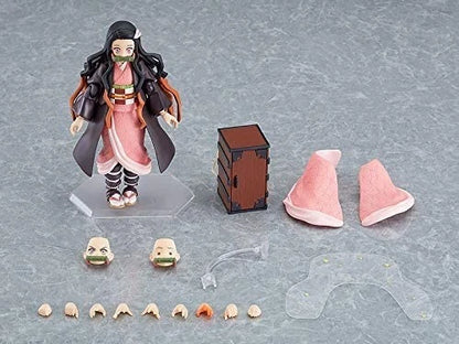 Action figure with accessories on a gray surface Max Factory figma Demon Slayer: Kimetsu no Yaiba: Nezuko Kamado Authentic Premium Action Figure – Deluxe DX Edition