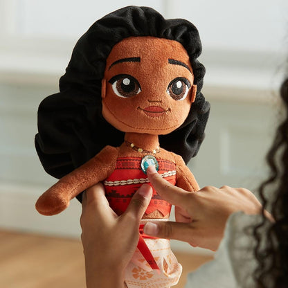 Plush toy of a character with black hair and red dress held by hands against a blurred background Official Disney Moana Wayfinder Princess – 14-Inch Premium Cotton Plush by Titantoons