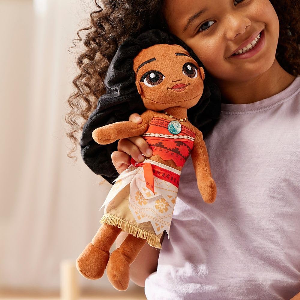 Child holding a Moana plush toy with a blurred background Official Disney Moana Wayfinder Princess – 14-Inch Premium Cotton Plush by Titantoons