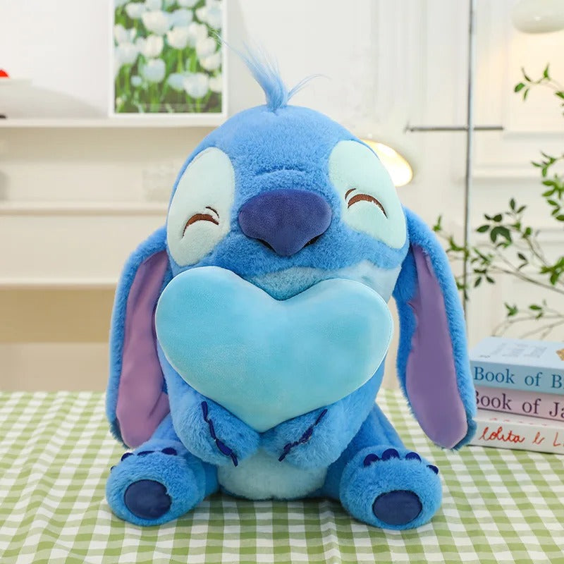 Blue plush toy with a heart on a checkered tablecloth Official Disney Stitch & Angel Hugging Heart Premium Cotton Plush Set by Titantoons