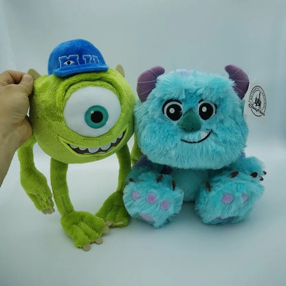 Two plush toys from Monsters Inc. on a white background, featuring Mike Wazowski in a blue cap and Sulley. Official Monsters University Sulley & Mike Premium Best Friends Plush Set by Titantoons