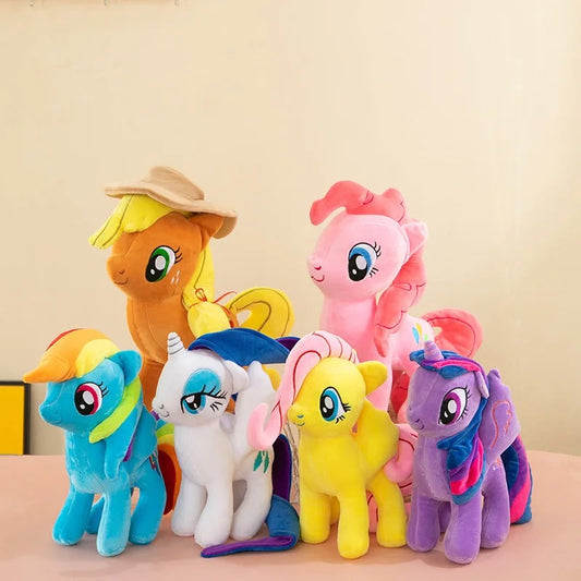 Set of colorful plush toy ponies on a beige background Official My Little Pony Rarity Premium Cotton Plush by Titantoons – Available in 8-Inch to 20-Inch