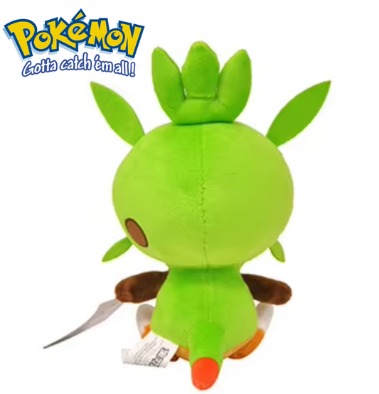 Green plush toy with leaf-like appendages on a white background, featuring the Pokémon logo. Official Pokémon Chespin Premium Cotton Plush by Titantoons – 11.5-Inch