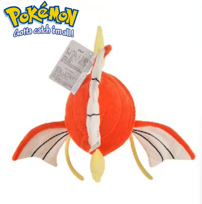 Plush toy of a dragon-like creature with a tag, featuring the Pokémon logo. Official Pokémon Magikarp Premium Cotton Plush by Titantoons – 11.5-Inch