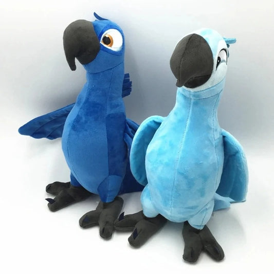 Two plush macaw toys from Rio, one blue and one light blue, standing side by side against a white background. Official Rio Blu & Jewel Premium Cotton Plush Collection by Titantoons