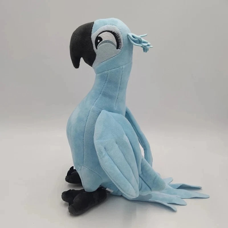 A light blue plush toy parrot with a black beak and black feet, sitting against a plain light gray background. Official Rio Blu & Jewel Premium Cotton Plush Collection by Titantoons