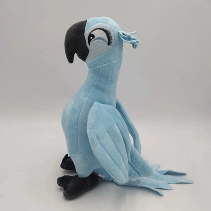 A light blue plush toy parrot with a black beak and black feet, sitting against a plain light gray background. Official Rio Blu & Jewel Premium Cotton Plush Collection by Titantoons