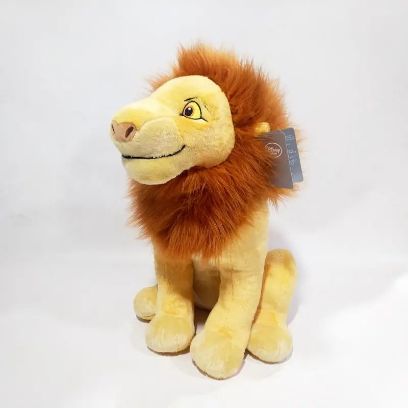 A plush lion toy with a golden-yellow body and a fluffy orange-brown mane, sitting on a plain white studio background. A small hangtag is attached near the mane. Official The Lion King Adult Simba Premium Cotton Plush by Titantoons side