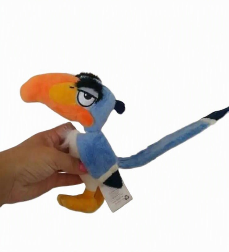 A hand holding a plush toy bird with a bright orange beak, blue body, white belly, and black details, against a plain white background. Official The Lion King Zazu Premium Cotton Plush by Titantoons