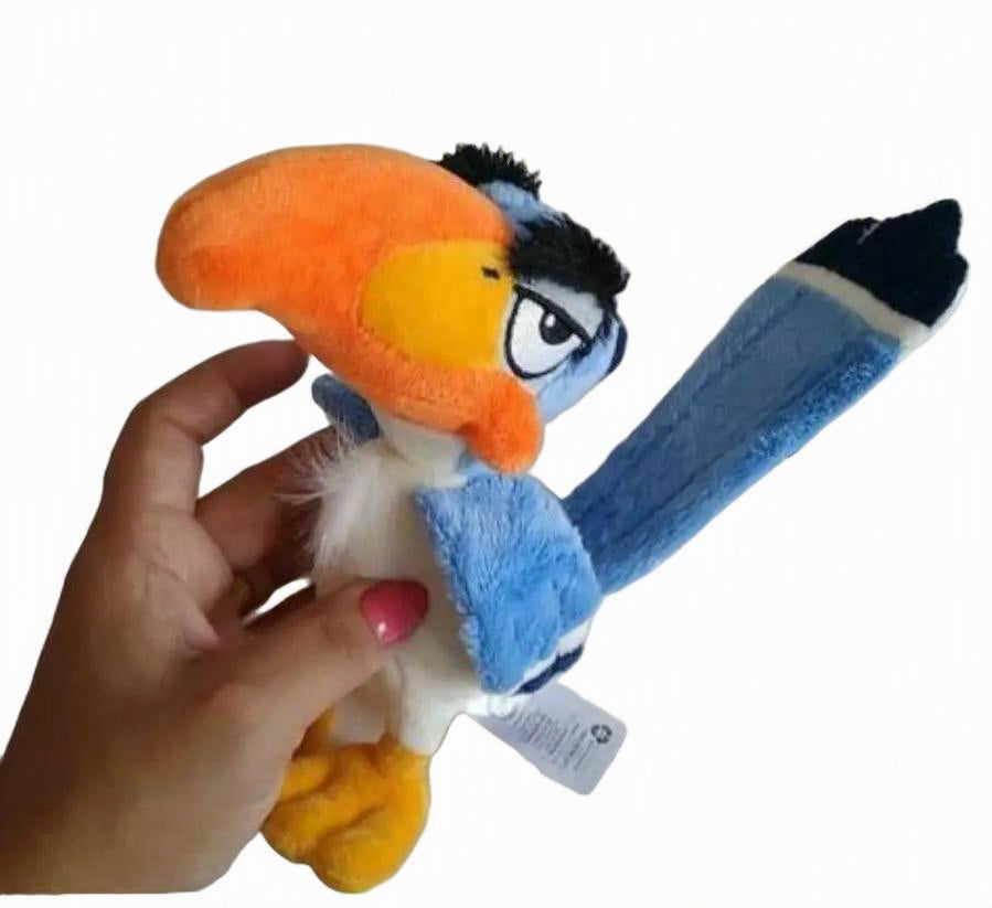 A plush toy bird being held by a hand against a plain white background. The toy has a bright orange beak, blue body, yellow feet, and a long blue tail with a black tip. Official The Lion King Zazu Premium Cotton Plush by Titantoons