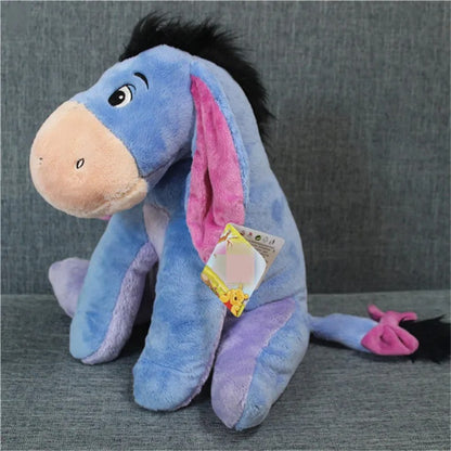 Plush toy resembling a donkey with a pink inner ear on a gray background. Official Winnie the Pooh & Friends Premium Cotton Plush Collection by Titantoons – Individual Storybook Characters or Complete 9-Piece Heirloom Nursery Set