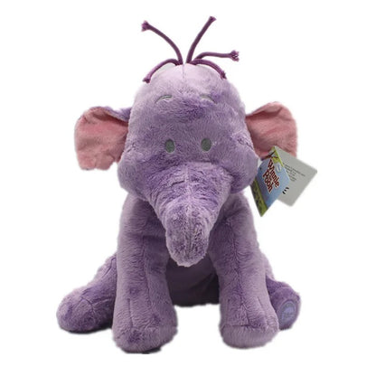 A purple plush elephant toy with pink inner ears, green bead eyes, and purple antennae on its head, sitting against a plain white background with a product tag attached. Official Winnie the Pooh & Friends Premium Cotton Plush Collection by Titantoons – Individual Storybook Characters or Complete 9-Piece Heirloom Nursery Set