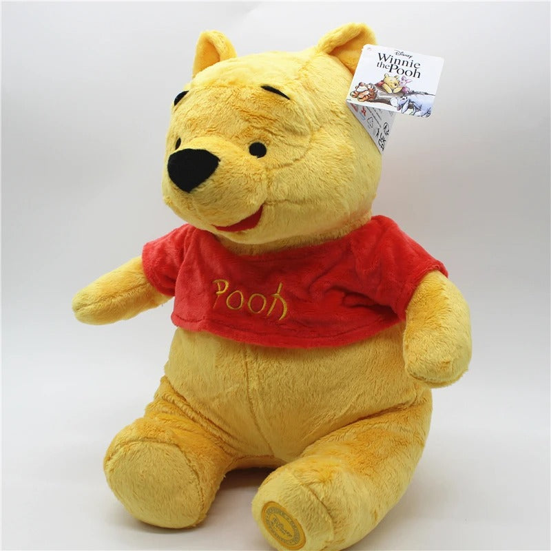 Plush toy of a bear wearing a red shirt with 'Pooh' on it, on a white background. Official Winnie the Pooh & Friends Premium Cotton Plush Collection by Titantoons – Individual Storybook Characters or Complete 9-Piece Heirloom Nursery Set