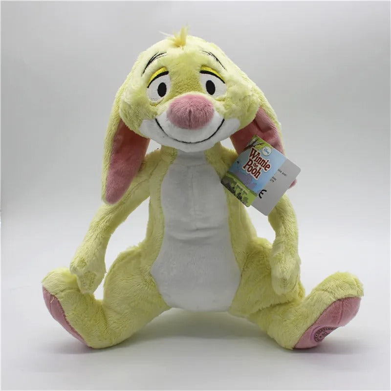 Yellow plush toy with a tag on a white background. Official Winnie the Pooh & Friends Premium Cotton Plush Collection by Titantoons – Individual Storybook Characters or Complete 9-Piece Heirloom Nursery Set