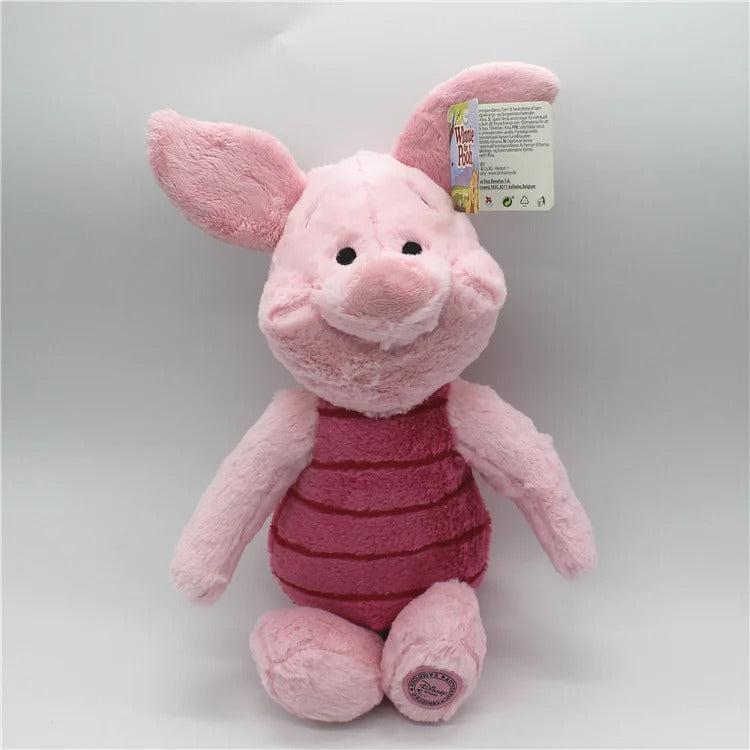 A plush toy of Piglet from Winnie the Pooh, wearing its signature pink striped shirt, sitting against a neutral light gray background with its retail tag attached to its ear. Official Winnie the Pooh & Friends Premium Cotton Plush Collection by Titantoons piglet