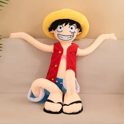 Plush toy of a character with a yellow hat and red shirt sitting on a couch. One Piece: Monkey D. Luffy Giant Luxury Anime Plush