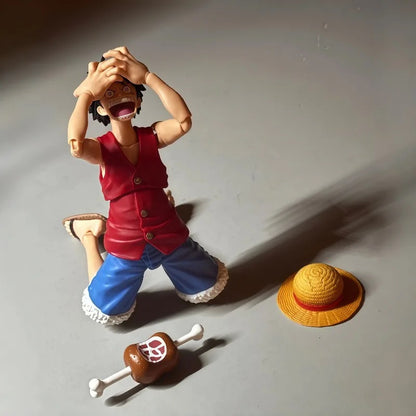 Action figure of a character in a red shirt and blue pants with a yellow hat on a gray surface One Piece: Monkey D. Luffy (Romance Dawn Ver.) Authentic S.H. Figuarts Fully Articulated Action Figure by Bandai Spirits